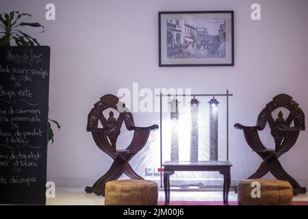 Wooden table with two wooden armchairs next to it in a hotel Stock Photo