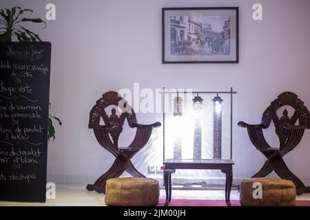 Wooden table with two wooden armchairs next to it in a hotel Stock Photo