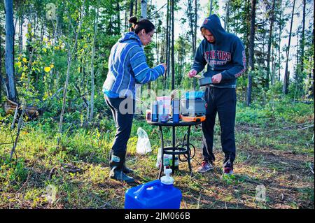 Mature couple preparing food in a camp Stock Photo