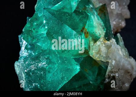A closeup of a rare mineral row uncut green and white crystal Stock Photo
