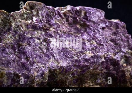 A closeup of a rare mineral row uncut purple crystal Stock Photo