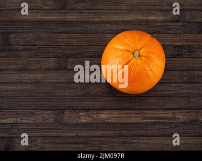 isolated orange on a wooden table, view from above Stock Photo