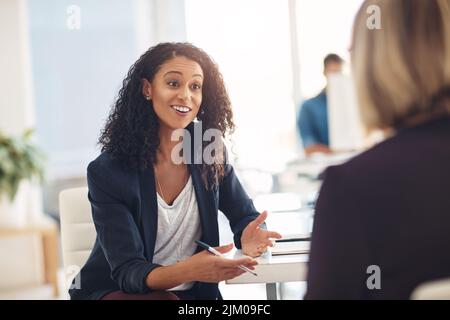Interview with a happy, excited and confident human resources manager talking to a shortlist candidate for a job. Young business woman meeting with a Stock Photo