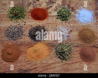 top view of different spices on a wooden tray Stock Photo