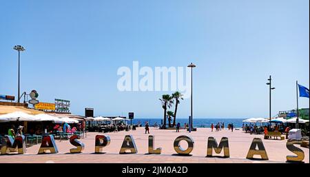 Large sign indicating the area name "Maspalomas" near the commercial area on the beach in Maspalomas, Gran Canaria, Spain Stock Photo