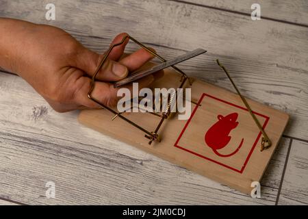 a woman's hand gets caught in a trap when she takes a credit card . people trapped by bank interests Stock Photo