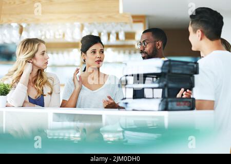 Diverse, listening and focused businesspeople in meeting talking, discussing and planning work schedule in modern workplace. Team leader having staff Stock Photo