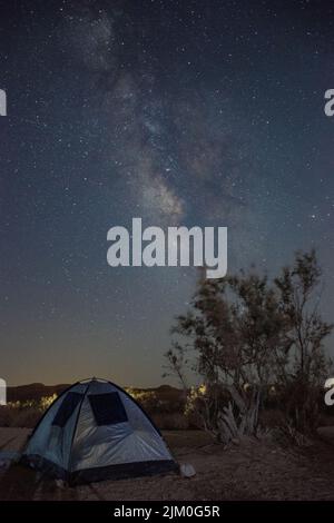 A tent against a beautiful night landscape with the Milky Way Stock Photo