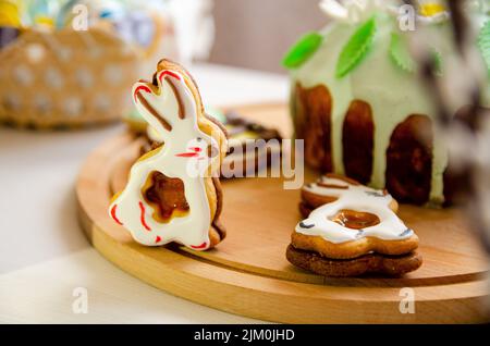 Easter bunny cookies and Ukrainian Easter bread (Paska Easter bread) on a round wooden plate Stock Photo