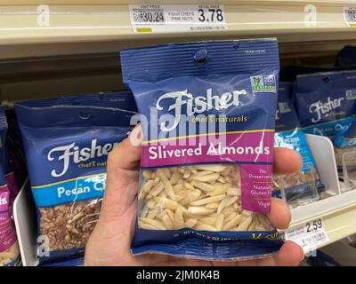 Augusta, Ga USA - 04 15 22: Hand holding Fisher bagged nuts Slivered Almonds retail store Stock Photo