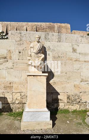 A vertical shot of an ancient statue of Menander at the historic  Acropolis in Athens, Greece Stock Photo