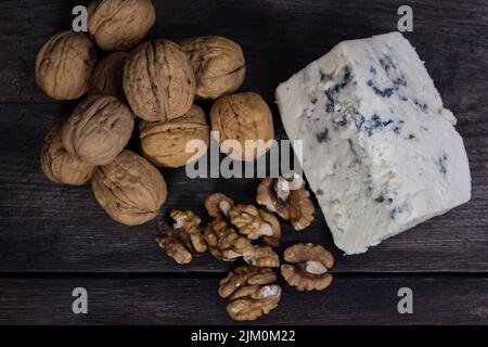 roquefort cheese with walnuts on dark background Stock Photo