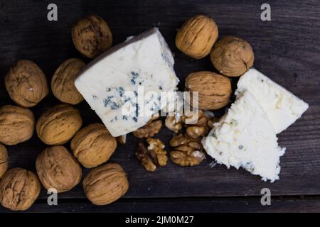 roquefort cheese with walnuts on dark background Stock Photo