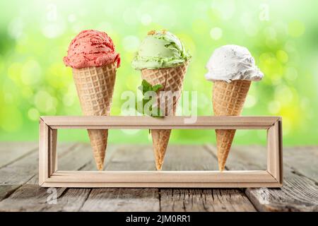 Various ice cream in waffle cones. Strawberry, pistachio and vanilla icecream Stock Photo