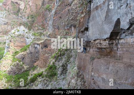 Hikers walk through the rugged mountain landscape of Madeira on their way to Pico Ruivo Stock Photo