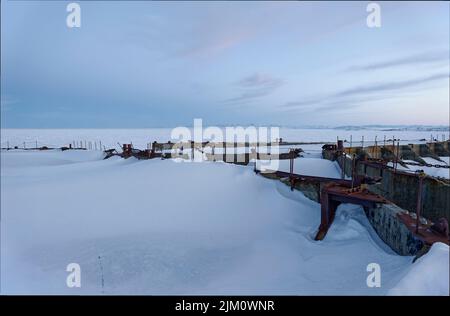 Oil drilling caissons, bottom founded near-shore in Thetis Bay, off the coast of Herschel Island in the Canadian Beaufort Sea in winter Stock Photo