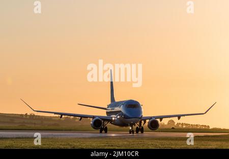 Cork Airport, Cork, Ireland. 04th August, 2022. A KLM Embraer 175 taxiing on the runway at dawn prior to departure for an early morning flight to Amsterdam from Cork, Airport, Ireland.- Credit; David Creedon / Alamy Live News Stock Photo