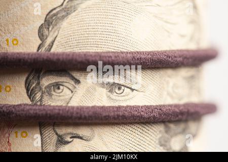 Portrait of Alexander Hamilton in Roll of Ten Dollar Bills. Stock Photo