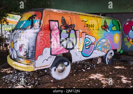 23 June 2022, Antalya, Turkey: Graffiti painted volkswagen hippie van as decoration Stock Photo