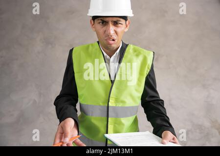 Angry arabic man engineer or architect wearing a hard hat pointing at ...