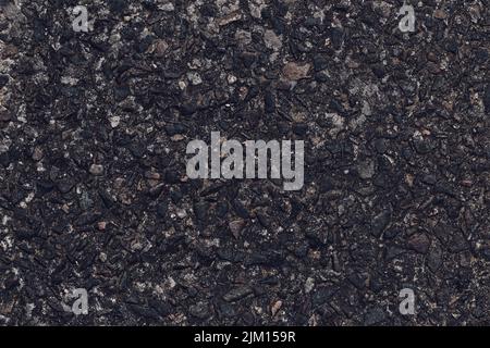 Asphalt texture, natural black pattern of roadway for design, grainy surface of pavement. Abstract dark wallpaper. Old weathered urban wall. Template Stock Photo