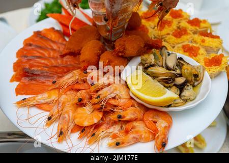 Red fish and boiled crayfish as an appetizer for beer. Stock Photo