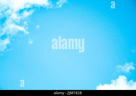 Blue sky blank space background with forming clouds in sunny day outdoors Stock Photo