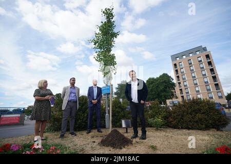 Doctor and best-selling author Adam Kay (right), who wrote BBC hospital drama This Is Going To Hurt, plants a tree at Ealing Hospital, west London, in commemoration of NHS staff who have taken their own lives. Kay's BBC drama features a moving scene where a tree is planted in memory of character Shruti, a doctor who committed suicide. After contact with the real-life hospital's CEO a memorial tree will now stand permanently on the hospitals grounds. Picture date: Thursday August 4, 2022. Stock Photo