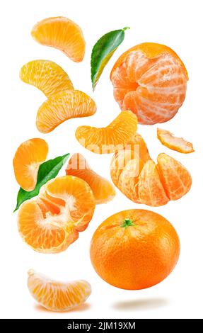 Levitating ripe tangerine fruits, leaves and mandarin slices on white background. File contains clipping paths. Stock Photo