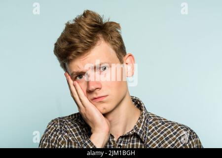 toothache sad depressed man pain holding cheek Stock Photo