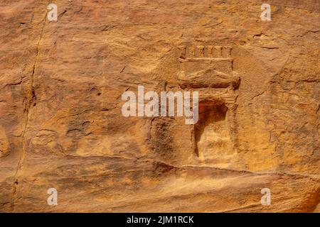 Nabatean rock carvings in Al-Siq the canyon entrance to Petra Jordan. Stock Photo