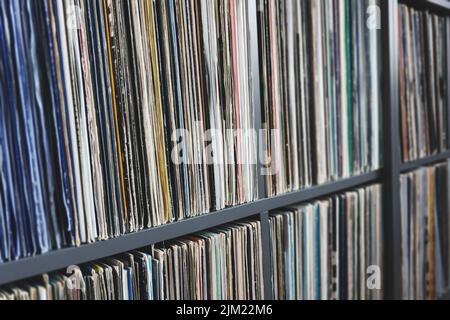 Vinyl records collection in old color covers on a shelf, side view with selective focus Stock Photo