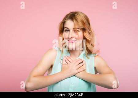 flattered girl smiling hand heart pleasant feeling Stock Photo