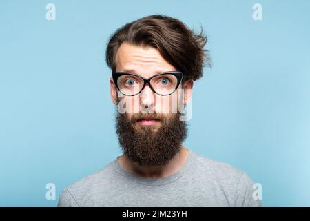 bearded hipster eye glasses nervous alarmed man Stock Photo