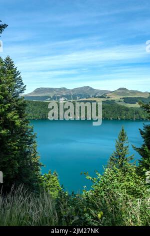 View on Volcanic Pavin lake located in the Regional Natural Park of Auvergne Volcanoes, Sancy massif in the background, Auvergne, France, Europe Stock Photo
