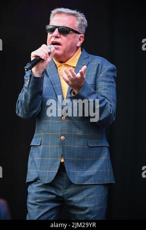 Lead Singer, Graham McPherson, known by his stage name Suggs, performs all the Hits with his Band Madness at Tramlines Festival in Sheffield. Stock Photo