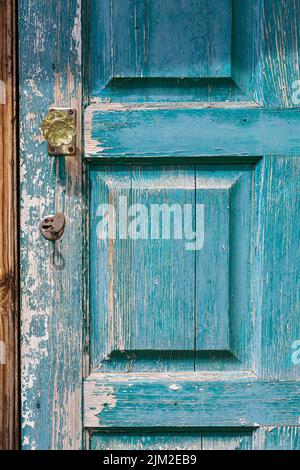 fragment of closed old wooden door with peeling paint Stock Photo