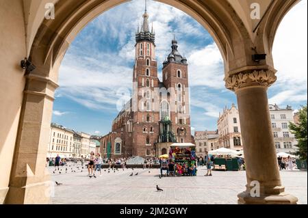 Krakow, Maloplskie voivodship, Poland; August 1st, 2022: St. Mary's Church seen from one of the Sukiennice arcades Stock Photo