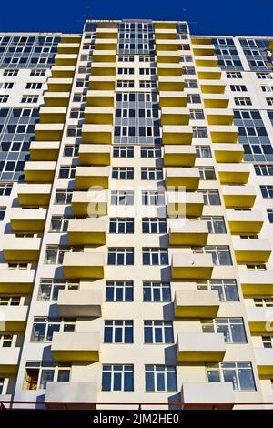 high new building with balcony and windows heap under construction on blue sky, modern technology diversity Stock Photo