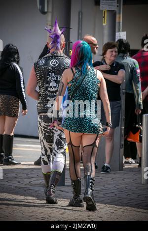 Blackpool, Lancashire, UK. 4th Aug 2022. The punk subculture, ideologies, fashion, with Mohican dyed hairstyles and colouring at the Punk Rebellion festival at The Winter Gardens. A protest against conventional attitudes and behaviour, a clash of anti-establishment cultures,  mohawks, safety pins and a load of attitude at the seaside town as punks attending the annual Rebellion rock music festival at the Winter Gardens come shoulder to shoulder with traditional holidaymakers.  Credit: Cernan Elias/Alamy Live News Stock Photo