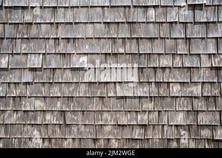 Close-up view of gray weathered shingles on typical Cape Cod building. Stock Photo