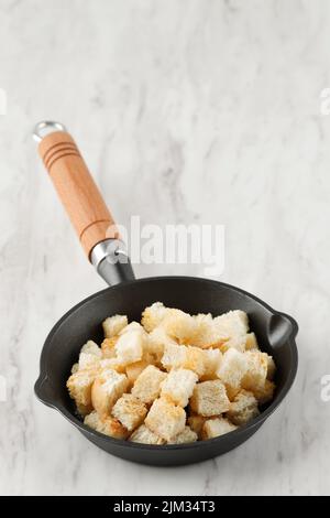Crispy Croutons on White Marble Table Stock Photo