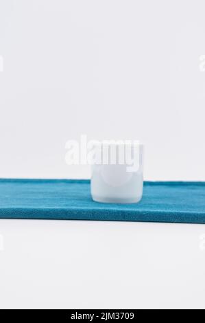 empty white bowl, vase on a green velvet table surface Stock Photo