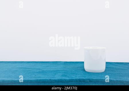 empty white bowl, vase on a green velvet table surface Stock Photo