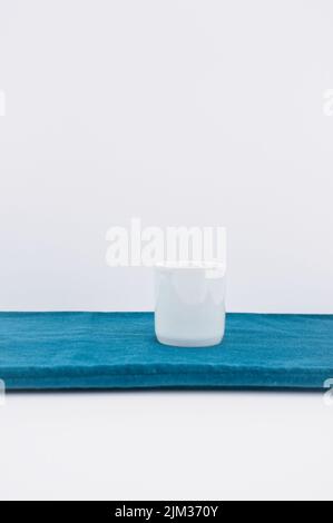 empty white bowl, vase on a green velvet table surface Stock Photo