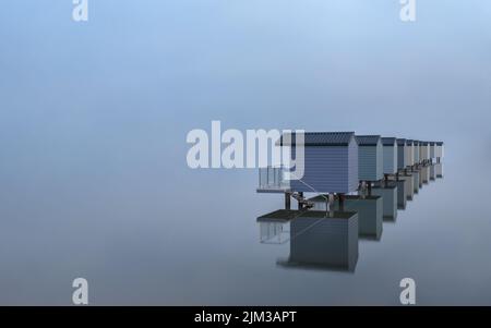 Minimalist image of multi-coloured beach huts and reflections at Osea on the River Blackwater in Essex Stock Photo