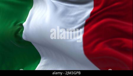 Close-up view of the italian national flag waving in the wind. Italy is a country located in the middle of the Mediterranean Sea, in Southern Europe. Stock Photo