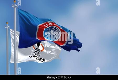Budapest HUN, July 2022: Flags with UEFA and UEFA Europa League waving in the wind. Europa League is an annual football club competition for european Stock Photo