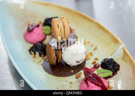 assortment of macaroons chocolate and raspberry ice cream leaves Stock Photo