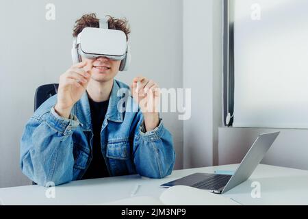 A young handsome freelancer working through VR glasses Stock Photo